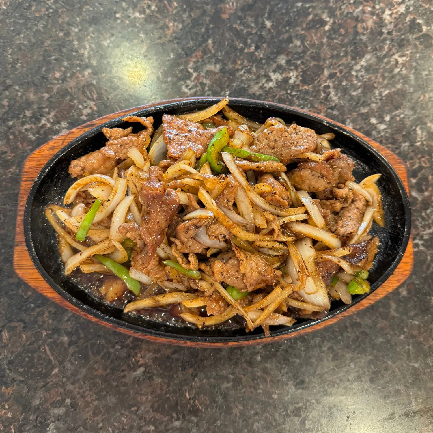 Sizzling pork stir-fried with onions and green peppers in black pepper sauce at China Palace Restaurant, a Chinese Restaurant in Milpitas